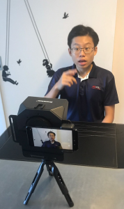 Howie focusing on his expressions for his 1 min EAE self-intro video.